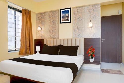 a bedroom with a large white bed in a room at POP 84342C Hotel Jashoda in Jodhpur