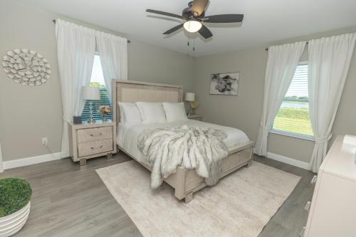 a bedroom with a bed and a ceiling fan at Lake Marlin Villa 2 in Port Charlotte