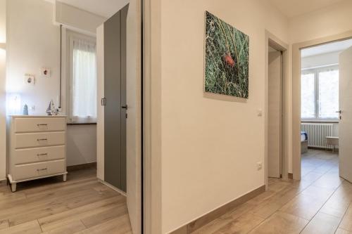 an empty room with a dresser and a painting on the wall at Giò Apartment on the beach front - mytouristhome in Portovenere