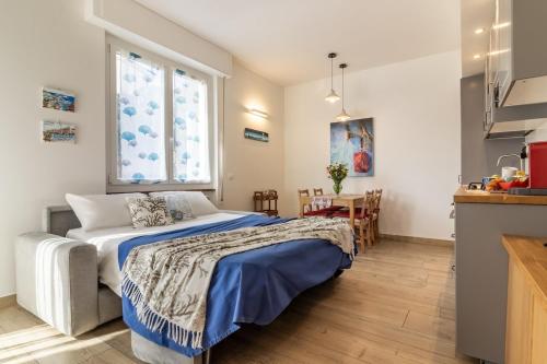 a bedroom with a bed and a window and a table at Giò Apartment on the beach front - mytouristhome in Portovenere