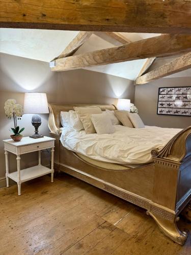 a bedroom with a large bed and a table at The old stables at flass in Maulds Meaburn