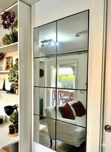 a room with a glass partition with a couch in it at The Attic in Civitavecchia
