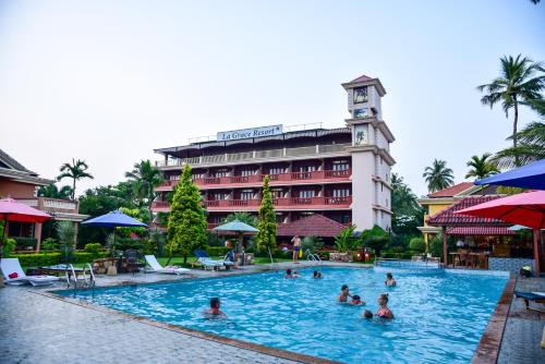 a group of people in a swimming pool at a hotel at La Grace Resort in Benaulim