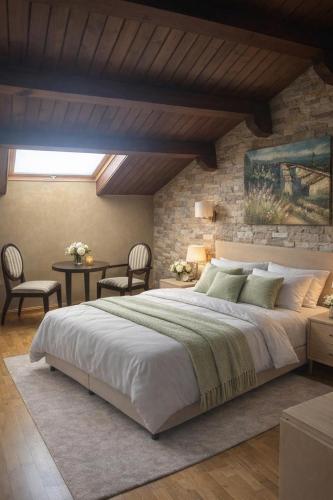 a bedroom with a large bed and a brick wall at Vestigia Nueva Castilla in Sigüenza