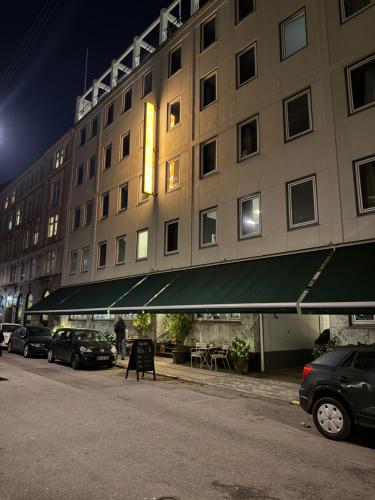 a large building with cars parked in front of it at Hotel Maritime in Copenhagen