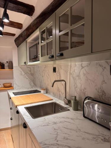 a kitchen with a sink and a counter top at La Rambla in Albarracín