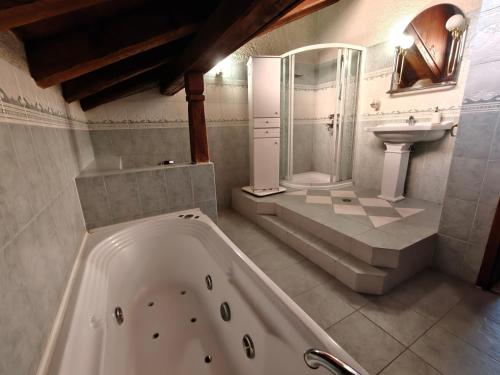 a bathroom with a tub and a sink at White Wolf Chalet in Bansko