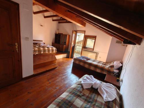 a bedroom with two beds and a living room at White Wolf Chalet in Bansko