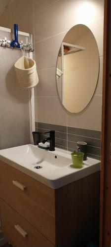 a bathroom with a sink and a mirror at A L ESCALE PASSA PAÏS in Le Poujol-sur-Orb