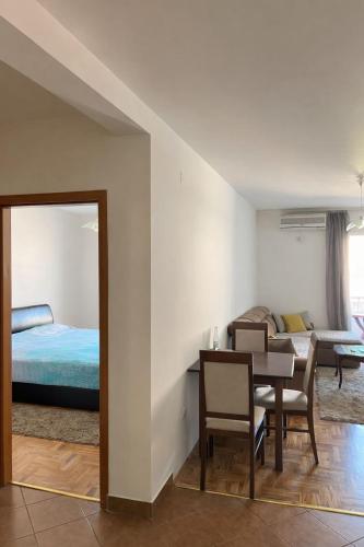 a room with a dining table and a bed at Apartment Tramonto Budva in Budva