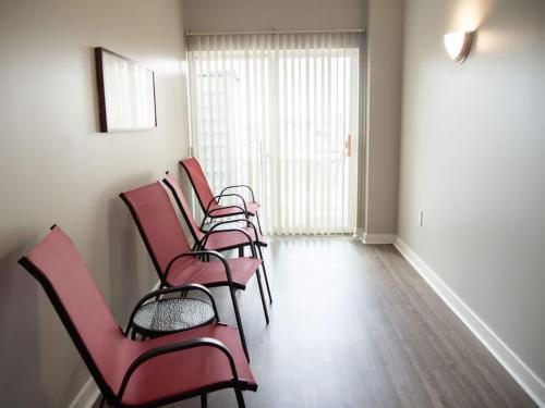 a row of red chairs in a waiting room at Historic 2BR stay with patio & elevator in Indianapolis