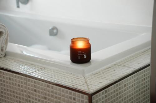 a candle sitting on the edge of a bath tub at Entire house perfect for group trips and families in Cape Town in Cape Town