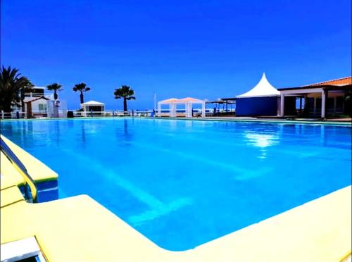 a large swimming pool with blue water at Studio Murdeira Side Beach, Eco Protected Bay, Pool 161B in Beirona