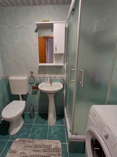 a small bathroom with a toilet and a sink at Apartment Tramonto Budva in Budva