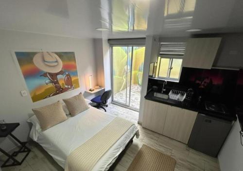 a bedroom with a bed and a desk and a window at Las Aguas Inner Experience in Bogotá