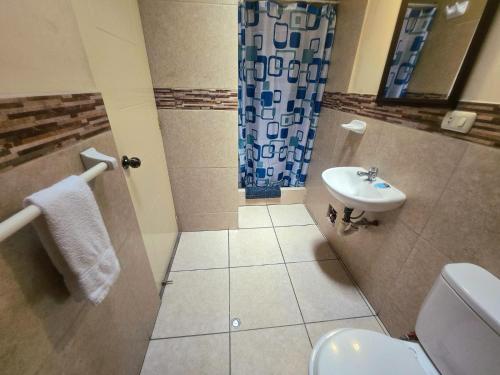 a bathroom with a toilet and a sink at Santa Marta Casona in Arequipa