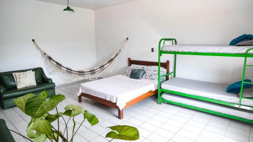a bedroom with two bunk beds and a couch at Recanto da Tuca in Socorro