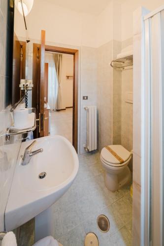 a bathroom with a white sink and a toilet at Hotel Umbria Orvieto-Nuova Gestione- in Orvieto