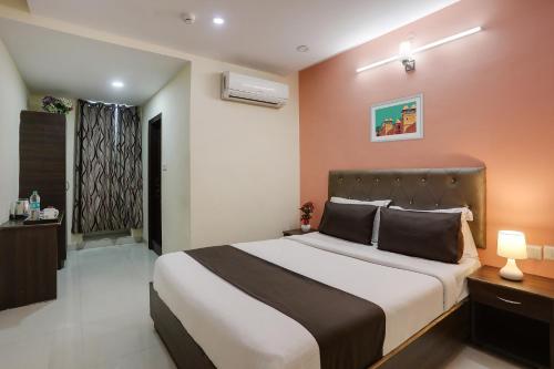 a bedroom with a large bed in a room at Collection O Lotus Grand in Hyderabad
