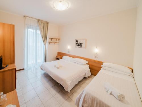 a hotel room with two beds and a television at Hotel Umbria Orvieto-Nuova Gestione- in Orvieto
