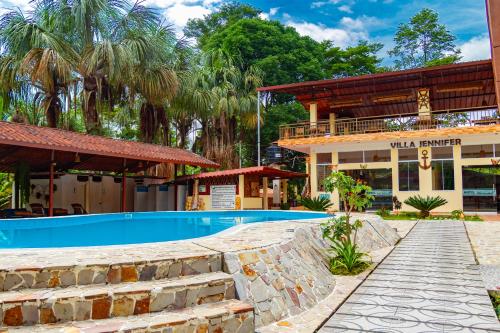a resort with a swimming pool and a building at Villa Jennifer in Tingo María
