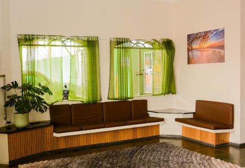 a living room with a couch and a window at Novo Maanaim Hotel in Presidente Epitácio