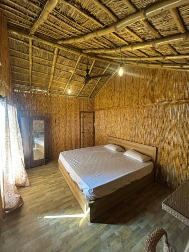 a bedroom with a bed in a wicker room at Bamboo Life in Dera Gopipur