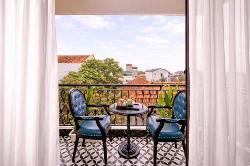 a balcony with a table and chairs and a view at Tam Coc Center Friendly Hotel in Ninh Binh