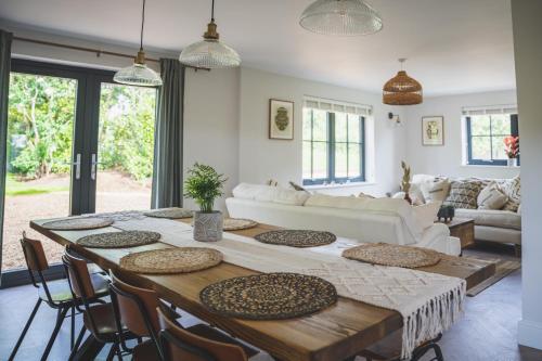 a living room with a table and a couch at Mill Farm in Gamlingay
