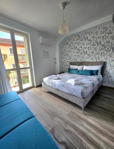 a bedroom with a large bed and a large window at B&B Fede e Natura in Caposele