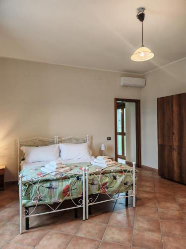 a bedroom with a bed in a room at Gli Ulivi del Nonno - Casale immerso nel verde a pochi chilometri dalla Reggia - in Caserta