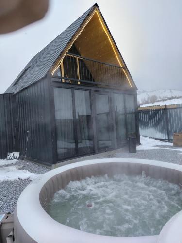 a hot tub in front of a building at Aparan HOUSE in Aparan