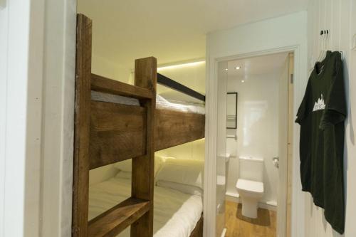 a room with a bunk bed and a bathroom at Cheviot Glamping Ltd in Ford