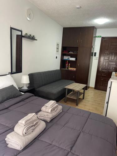 a bedroom with a bed with towels on it at Helios in Ioannina