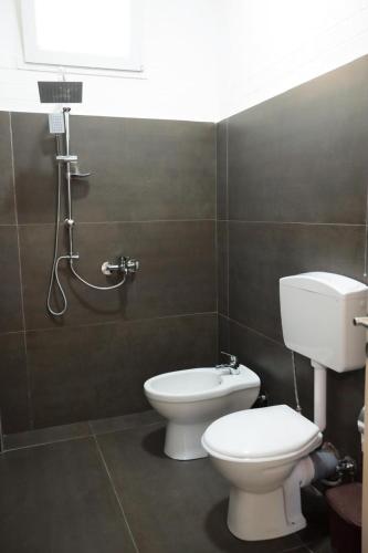a bathroom with a toilet and a sink and a shower at House Leon in Krujë