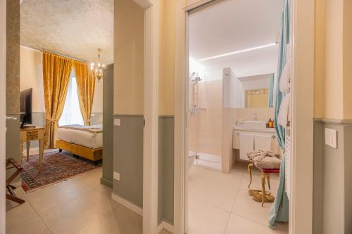 a bedroom with a bed and a bathroom with a sink at Corte Realdi Suites Arena Verona in Verona