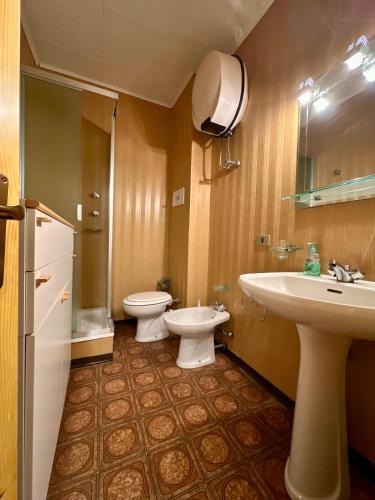 a bathroom with two toilets and a sink at Il rifugio di Pietro in Sella della Turra