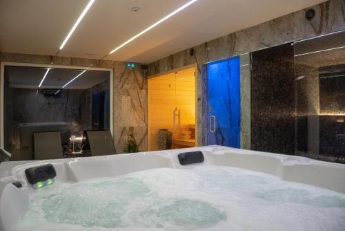 a bathroom with a large tub with water in it at Arouca Passadiços Alojamento & Jacuzzi - SPA in Arouca
