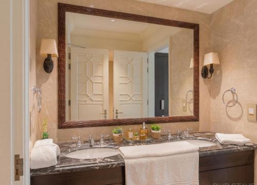 a bathroom with two sinks and a large mirror at The St Regis Luxury in Cairo