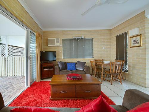 a living room with a couch and a table at Murray Street Apartments in Rockhampton