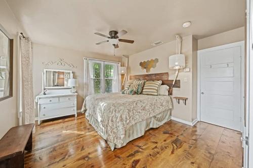 a bedroom with a bed and a ceiling fan at Suite Elliana w/Hot Tub & Outdoor Fireplace! in Fredericksburg
