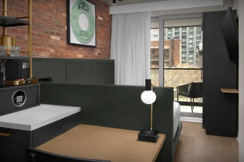 a room with a counter and a table and a window at The Livingston, part of JdV by Hyatt in Brooklyn