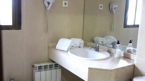 a bathroom with a sink and a mirror at Hotel Recio in Santa Olalla de Toledo