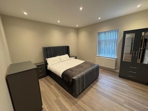 a bedroom with a bed and a dresser and a window at Brand New Luxury Centrally Located 2BR Apartment in Horninglow