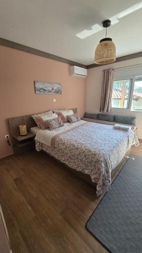 a bedroom with a large bed in a room at Semelia & Maria's Guest Houses - Cozy Stay for 2 in Spata