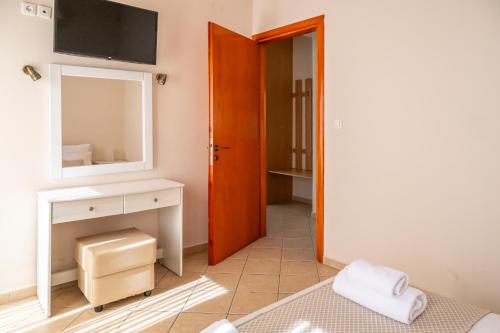 a bedroom with a sink and a mirror and a bed at So Nice Hotel in Marathokampos