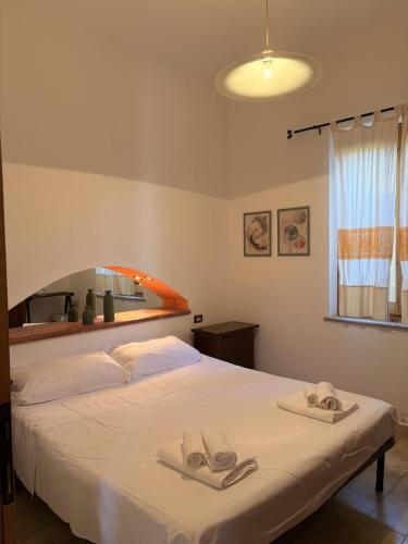 a bedroom with a bed with two towels on it at Villa Irmā in Tertenìa