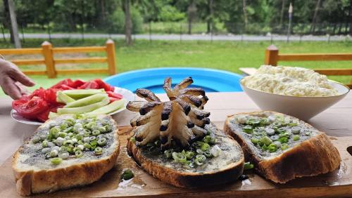 a plate of food with bread and vegetables on a table at Old Chalet Apuseni in Arada