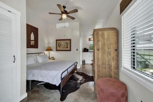 a bedroom with a bed and a ceiling fan at Tejas Suite Walking Distance to Main St! in Fredericksburg