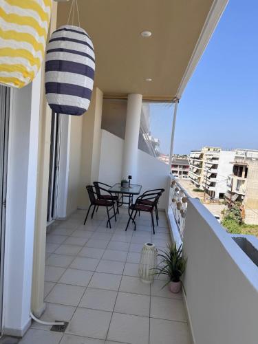 a balcony with a table and chairs on it at J&J spacious balcony apartment in Preveza